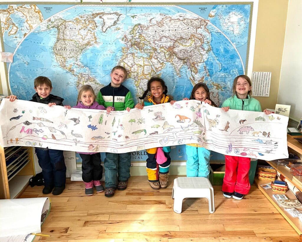 Montessori Admissions page image of Children learning about maps and animals