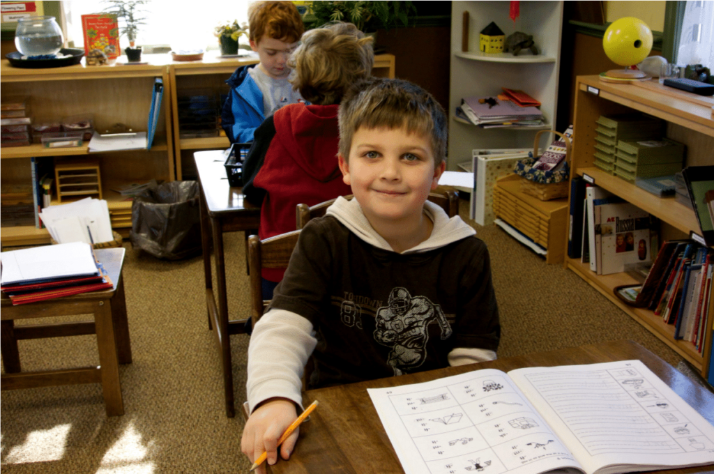 Student sitting and learning at the Country Village Montessori School